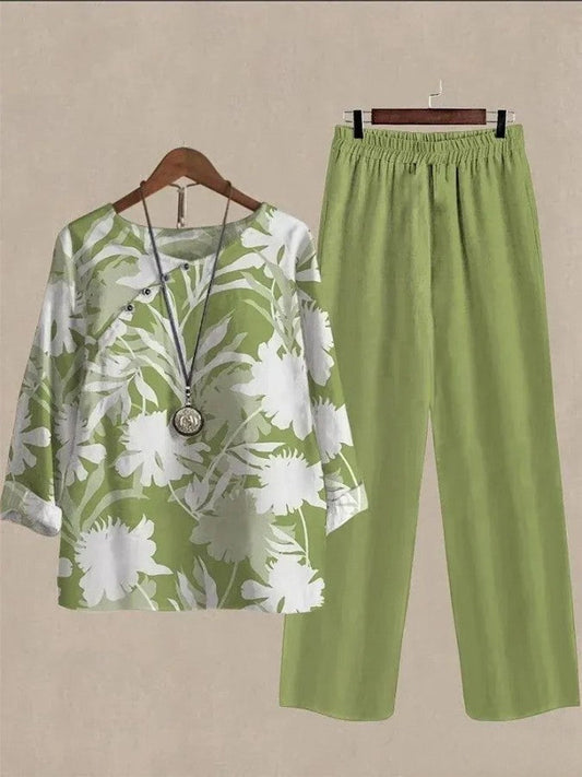 jumpsuit met lange mouwen, groene plantenprint en ronde hals.